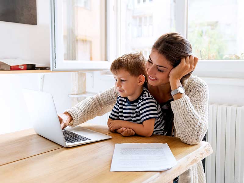 mother and son using laptop